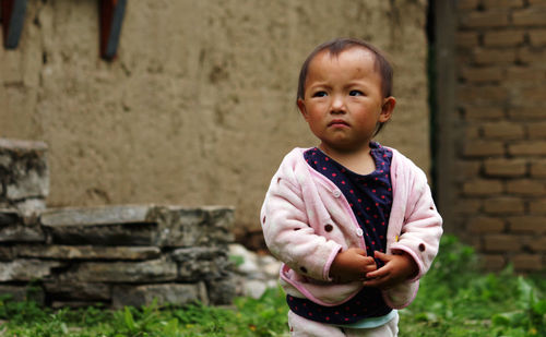 Portrait of cute girl standing outdoors