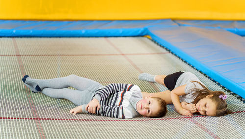 Low angle view of people resting on carpet