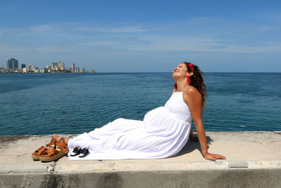 Woman on beach against sky