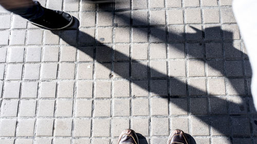 Low section of person standing on shadow