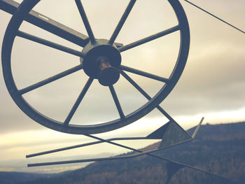 Low angle view of wheel against sky
