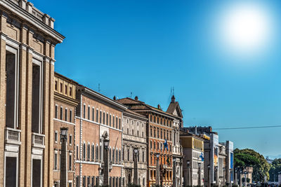 Low angle view of buildings against blue sky