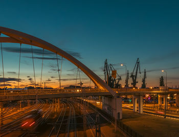 Illuminated bridge against sky at night