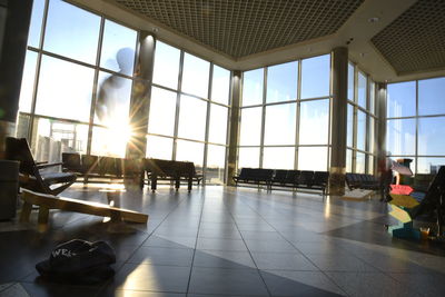 People on glass window at airport