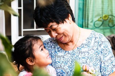 Smiling grandmother and daughter at home