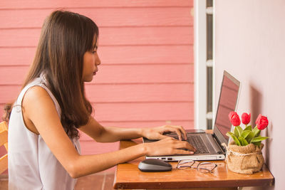 Young woman using laptop at home