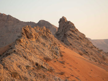 Rock formations in desert against clear sky