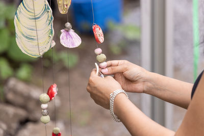 Cropped hand of woman holding light bulb