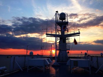Navy ship against orange sky