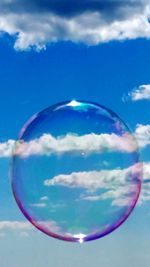 Close-up of bubbles against blue sky