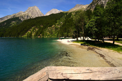 Scenic view of lake by trees against sky