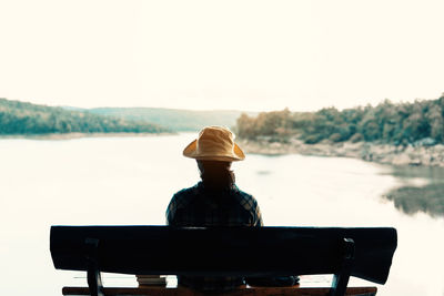 Rear view of man sitting on bench