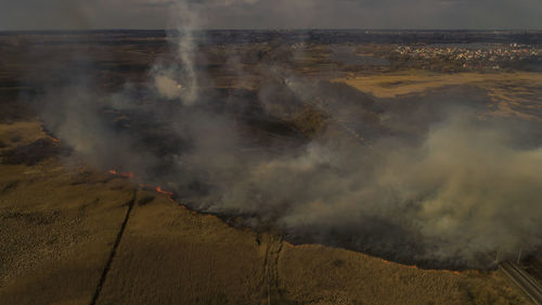 Massive fire, dry grass lanes in fire, firefighters at work, disaster, ecological catastrophe