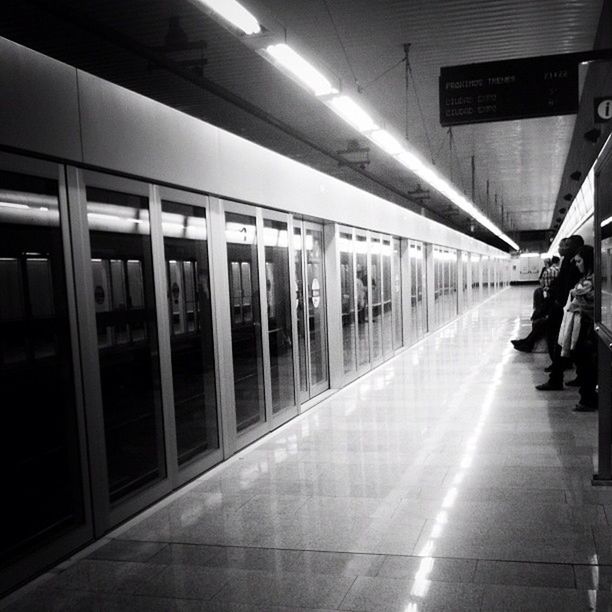 illuminated, railroad station, public transportation, indoors, transportation, railroad station platform, men, subway station, built structure, travel, architecture, lifestyles, person, city life, rail transportation, walking, subway, airport, large group of people