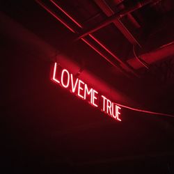 Low angle view of illuminated information sign at night