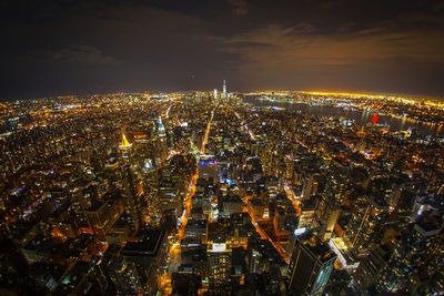 Aerial view of illuminated cityscape against sky at night