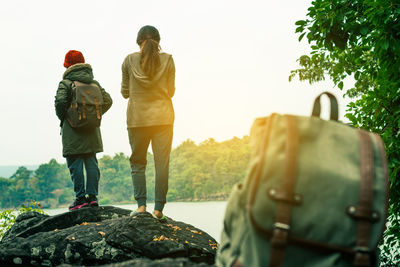 Close-up of bag on rock with people in background