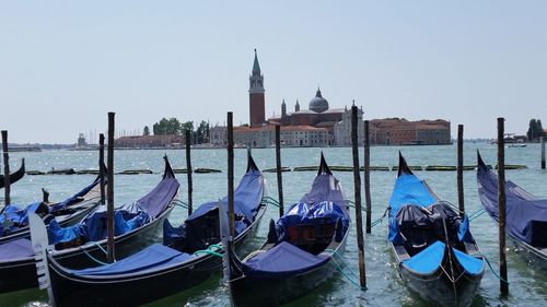 Gondolas moored on grand canal against st marks square