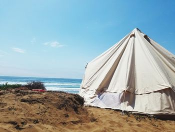 Tent on beach against sky