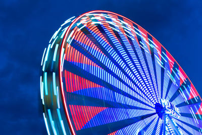 Low angle view of illuminated ferris wheel against sky at night