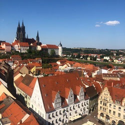 High angle view of old buildings in town against sky