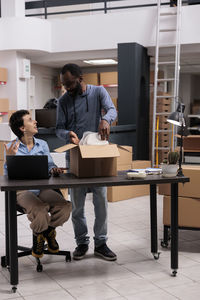 Side view of business colleagues working at office