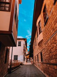 Street amidst buildings in city against sky