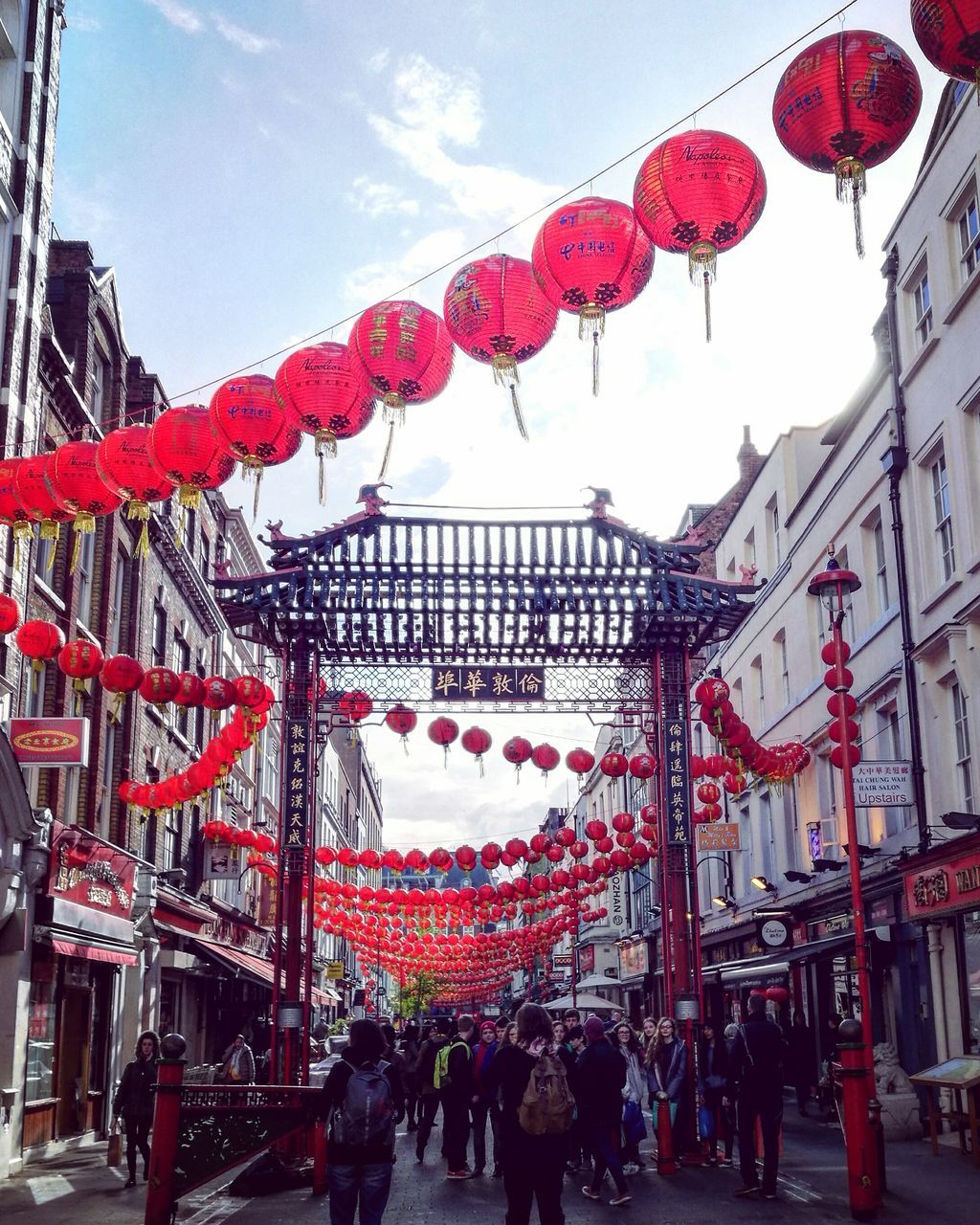 built structure, large group of people, building exterior, architecture, hanging, red, day, sky, celebration, outdoors, mixed age range, real people, women, city, men, lantern, low angle view, people