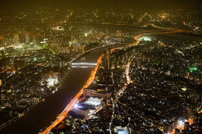 High angle view of illuminated buildings in city at night