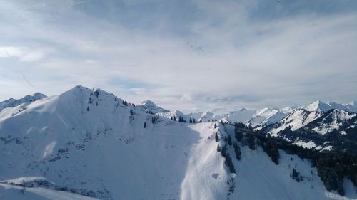 Panoramic view of snowcapped mountains against sky