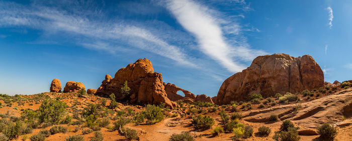 View of rock formations in desert against blue sky