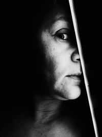 Close-up portrait of woman in darkroom