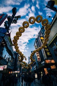 Low angle view of decorations hanging amidst buildings in city