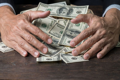 Close-up of hand with tattoo on table