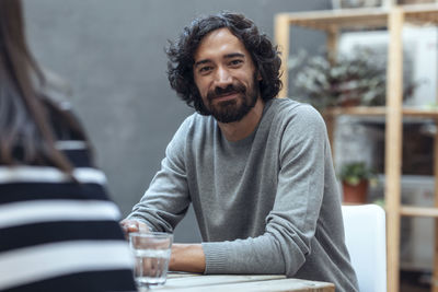 Creative businessman sitting at table in office cafeteria