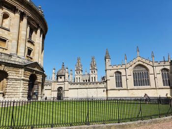 Panoramic shot of buildings against clear blue sky