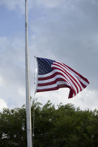 Low angle view of flag against sky