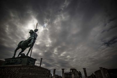 Low angle view of statue against cloudy sky