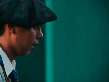 Portrait of young man looking away wearing beret 