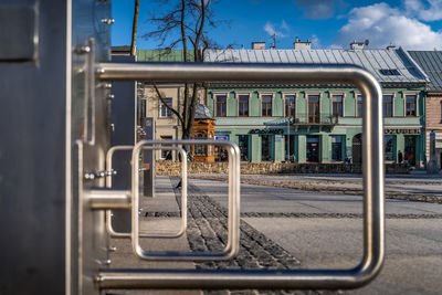 Train on railroad track in city against sky