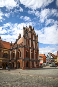 Buildings against cloudy sky