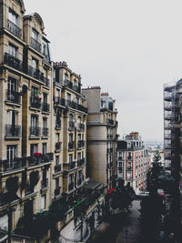 Buildings in city against clear sky