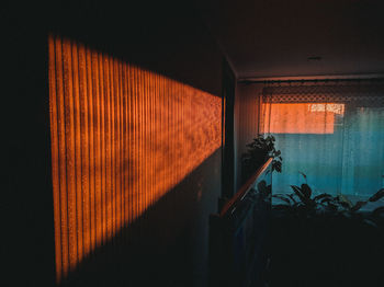 Illuminated building seen through window at night