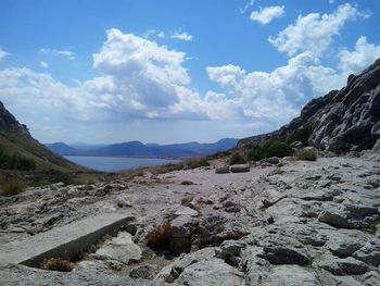 Scenic view of mountains against cloudy sky