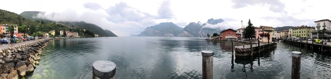 Panoramic view of buildings against cloudy sky