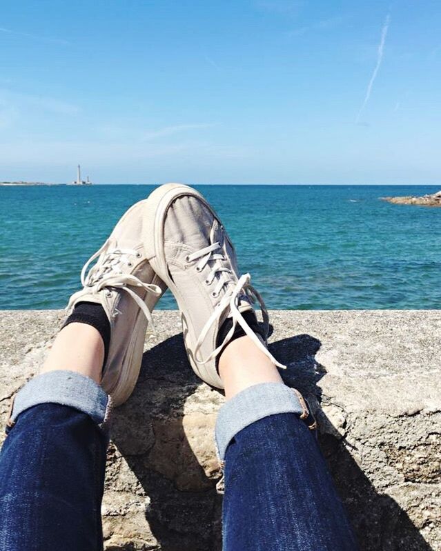 LOW SECTION OF PEOPLE RELAXING ON BEACH