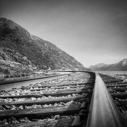 Railway tracks leading towards mountains