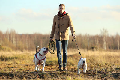 Man with dog standing on land