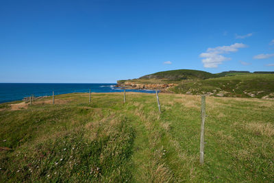 Scenic view of sea against clear blue sky