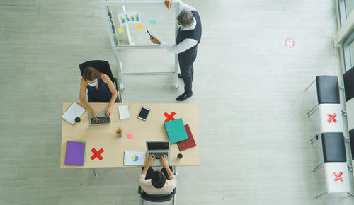 High angle view of people standing on table